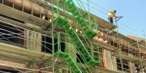 Green scaffolding system with stairs on a construction site in Brooklyn