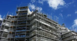 Multi-story building covered in metal scaffolding.