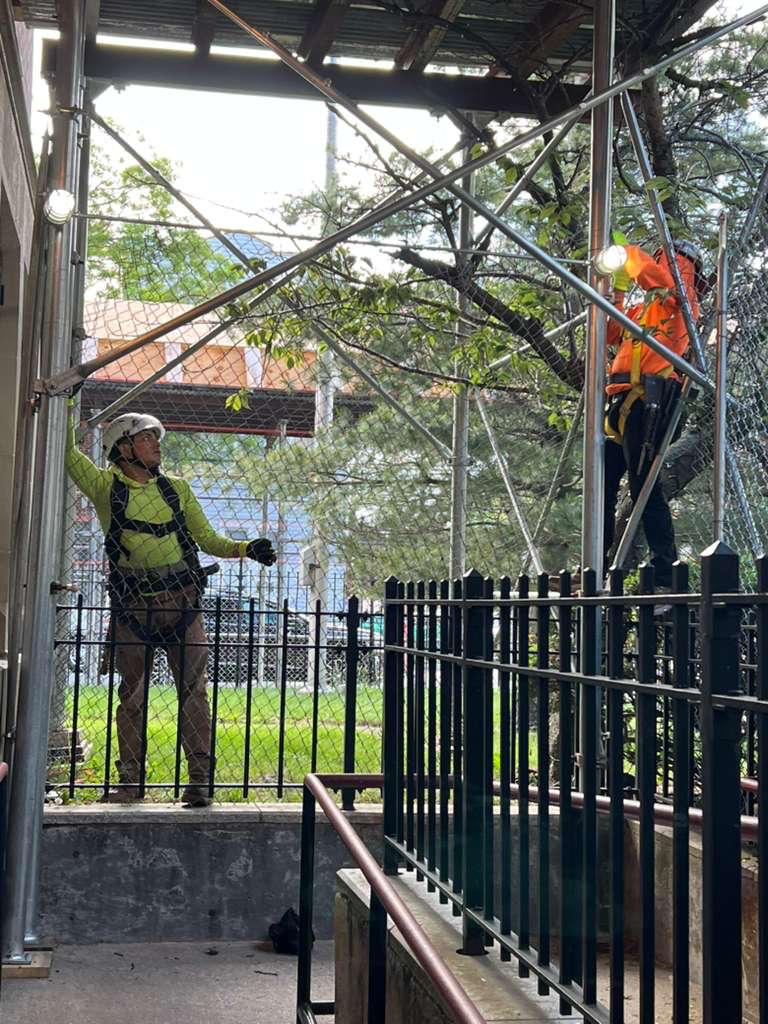 Experienced installation crew working on scaffolding